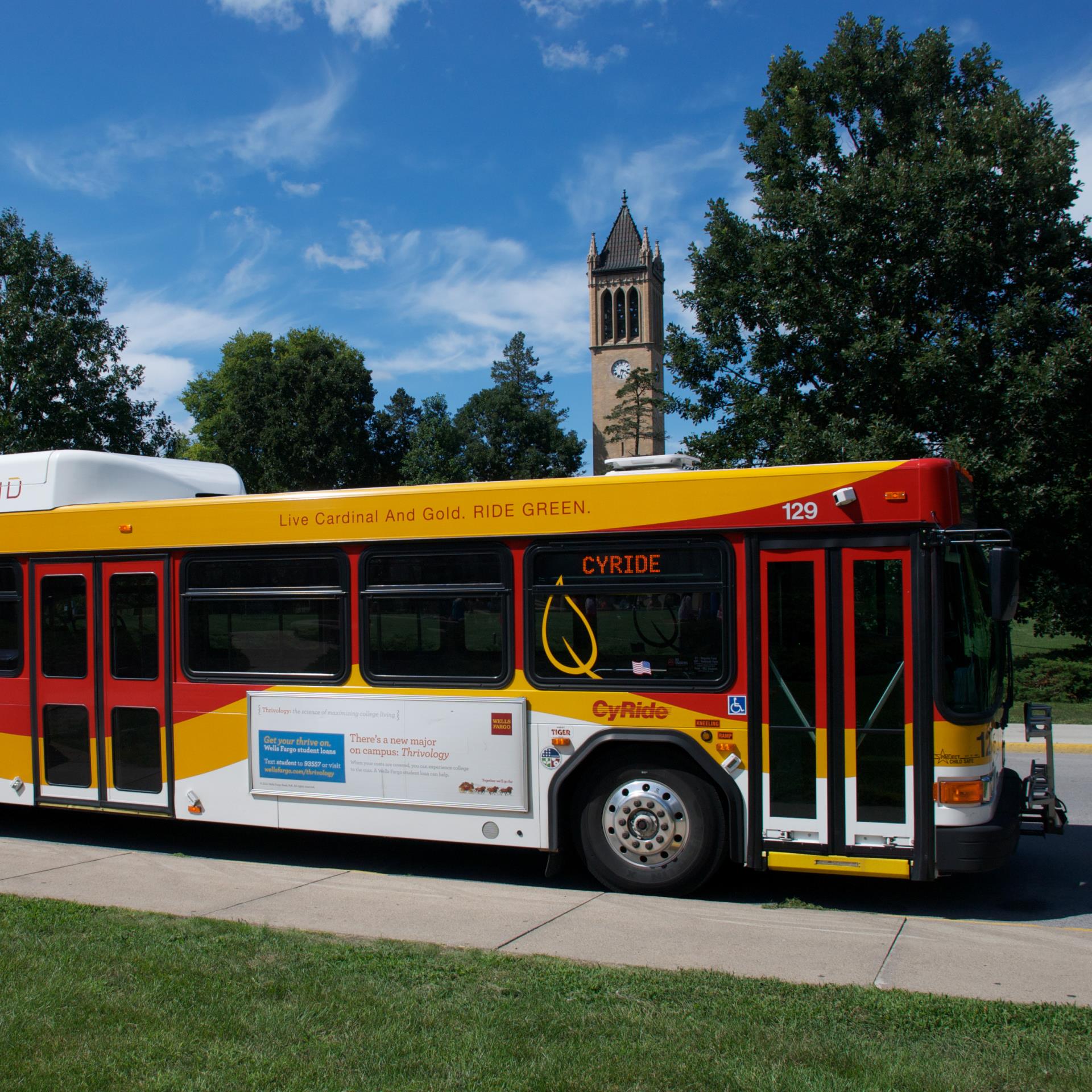 Hybrid bus at Memorial Union bus stop with Campanile in distance